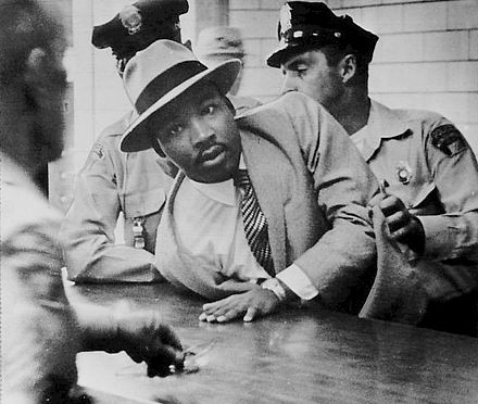 Dr. Martin Luther King, Jr. getting arrested.